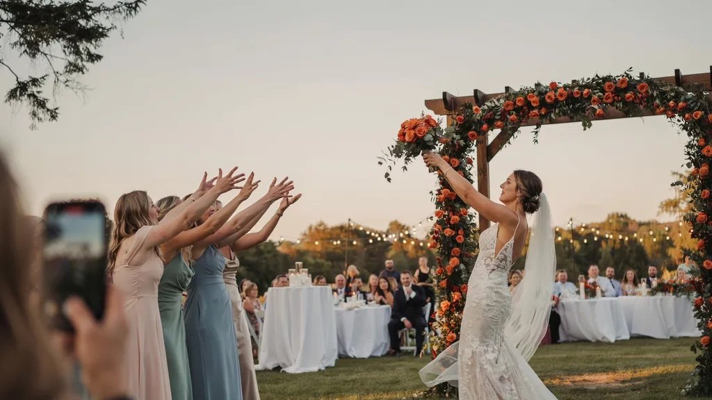 A bride tossing a bouquet of orange roses at her wedding for the single ladies to catch.