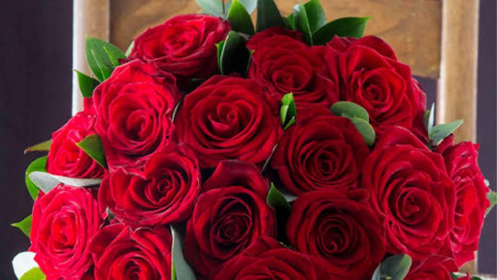 Lush red rose bouquet with green leaves, representing Libra's passion and deep appreciation for beauty.