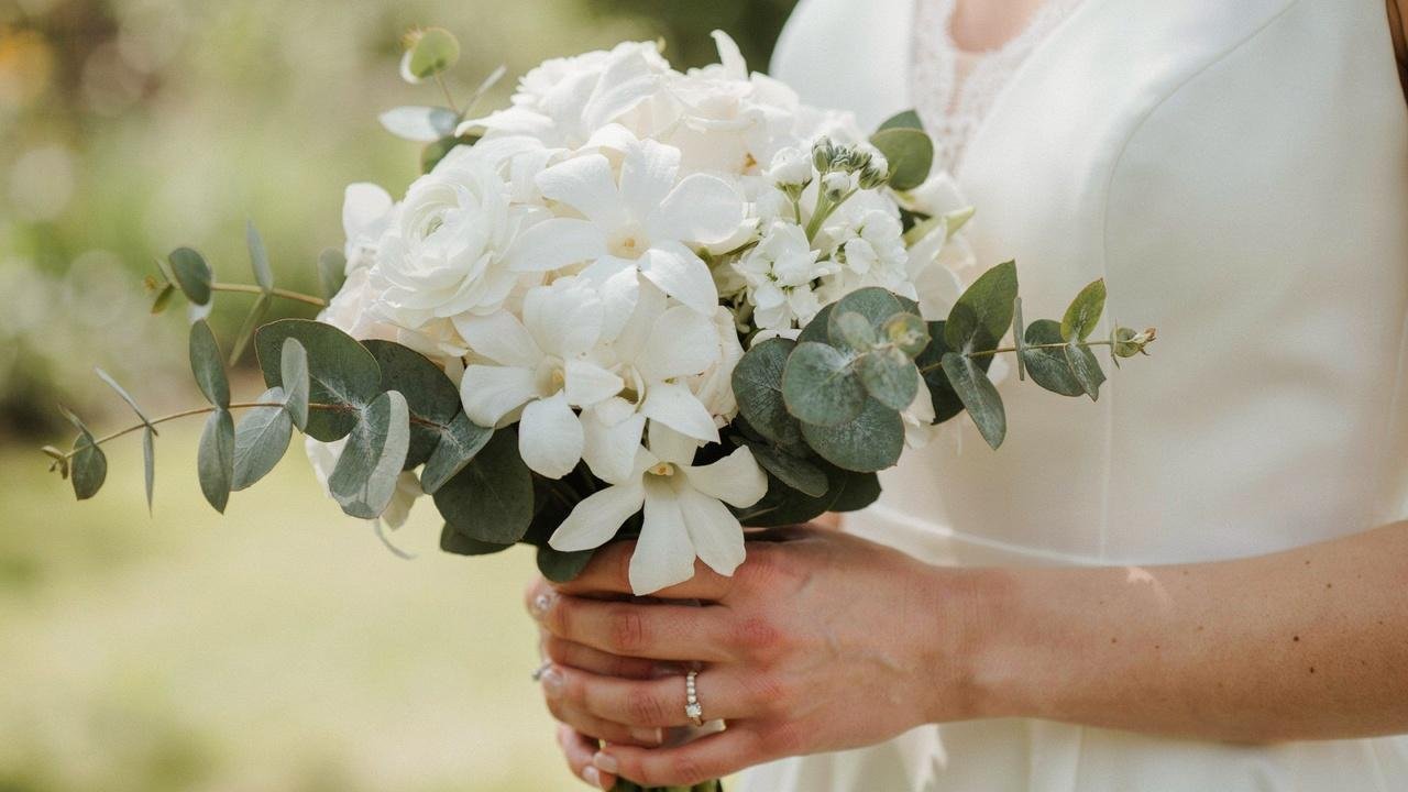 White stephanotis flowers symbolizing purity, innocence, and sincere affection in an elegant wedding bouquet.